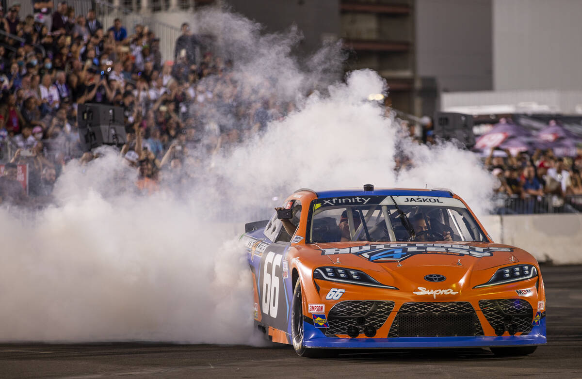 A car burns out for the fans packed into the stands as the car Cruise rolls by during the car C ...
