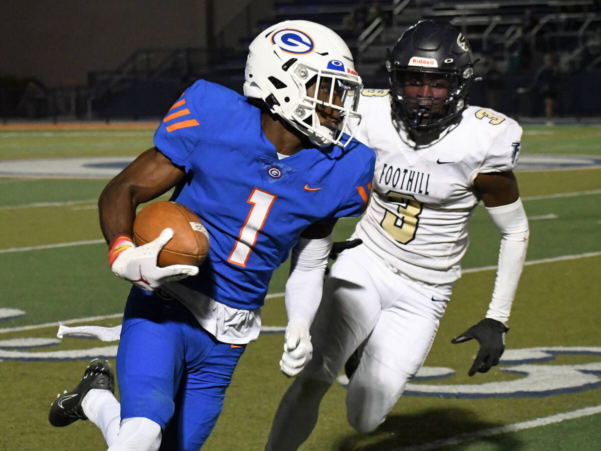 Bishop Gorman wide reciever Zachariah Branch runs from Foothill defender Kendric Thomas during ...