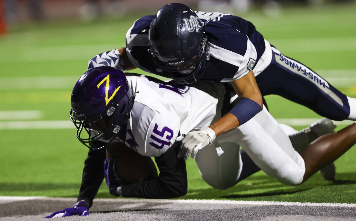 Durango's Sterling Lewis (45) scores a touchdown as Shadow Ridge's Jonah Ruiz (9) makes the tac ...