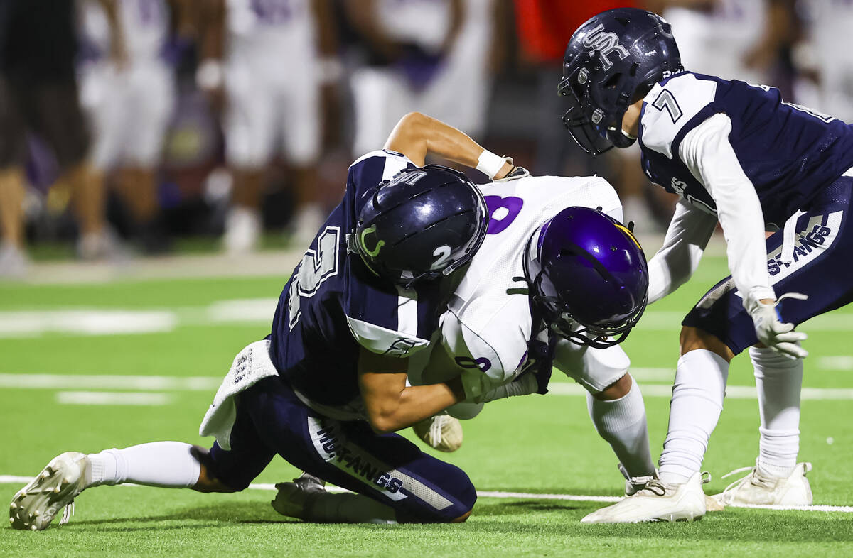 Shadow Ridge's Kela Cox (2) takes down Durango's Tanner Nitsche (8) in front of Shadow Ridge's ...