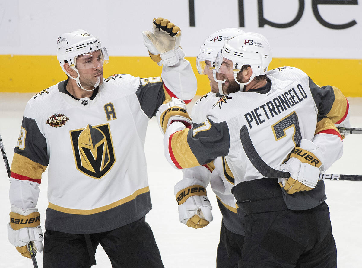Vegas Golden Knights' Dylan Coghlan, center, celebrates with teammates Alex Pietrangelo (7) and ...