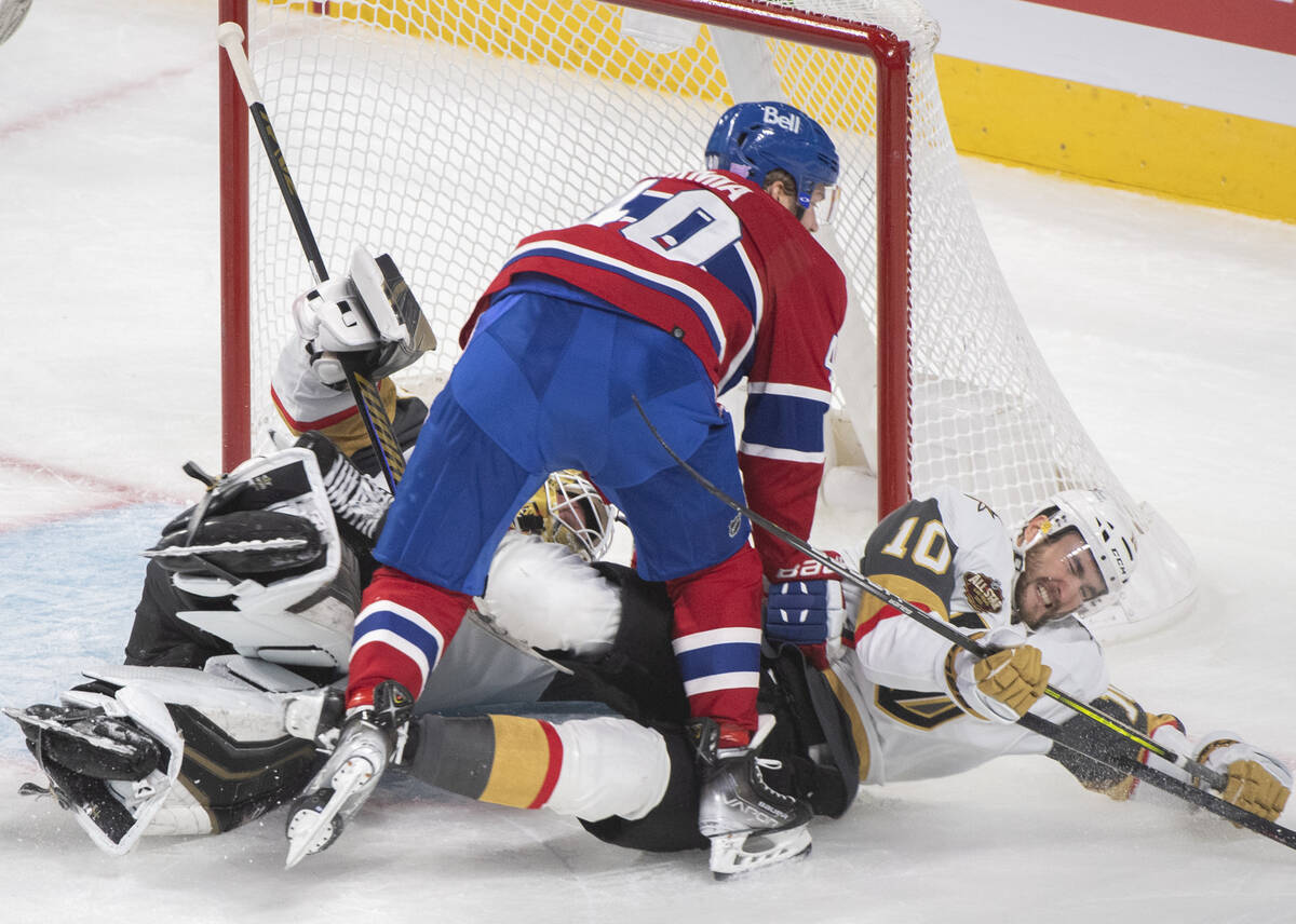 Vegas Golden Knights' Nicolas Roy (10) falls over Golden Knights goalie Robin Lehner as Montrea ...