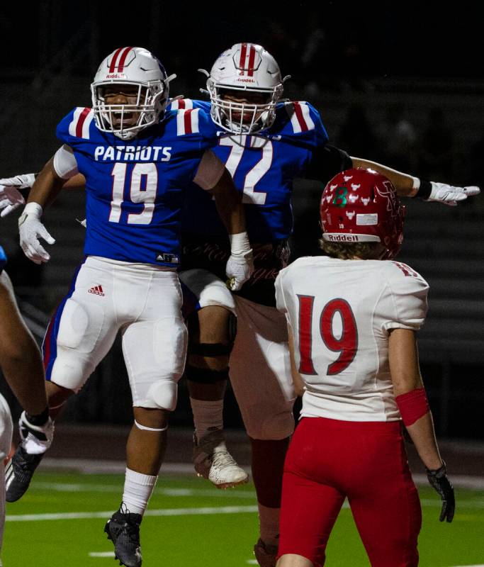 Liberty High halfback Isaiah Lauofo (19) celebrates his touchdown with teammate Jacob Maiava as ...