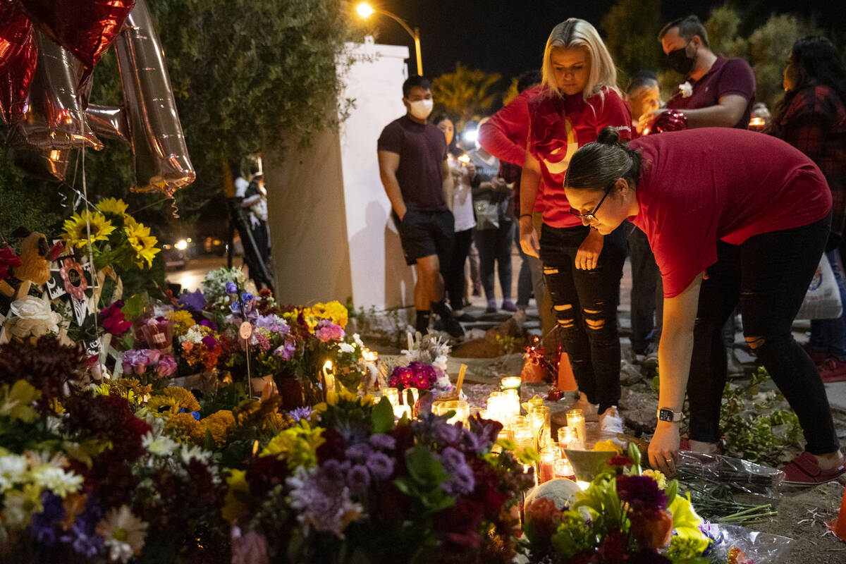 Arrianna Spring drops off flowers during a vigil for her coworker Tina Tintor and her dog Max a ...