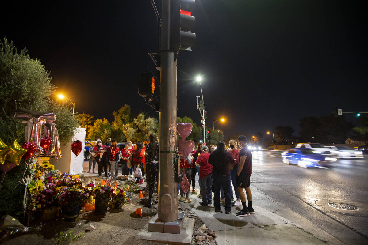 People attend a vigil for Tina Tintor and her dog Max at a memorial on Rainbow Boulevard and Sp ...