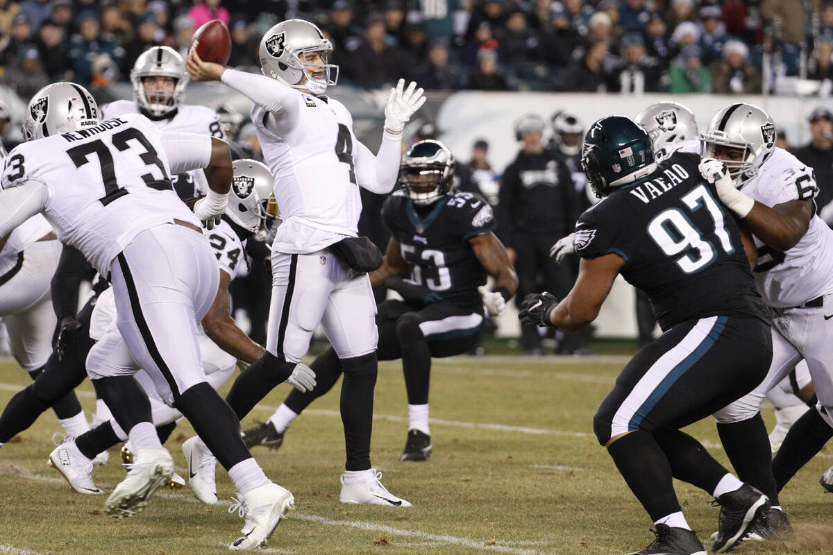 Oakland Raiders' Derek Carr passes during the first half of an NFL football game against the Ph ...