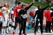 UNLV coach Marcus Arroyo, front left, gestures to players during the first half of an NCAA coll ...