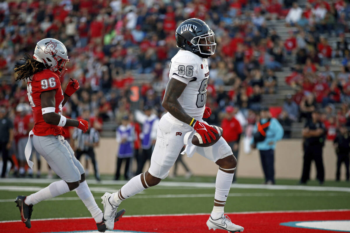 UNLV wide receiver Marcus Phillips Jr. (86) scores a touchdown past New Mexico cornerback Corey ...