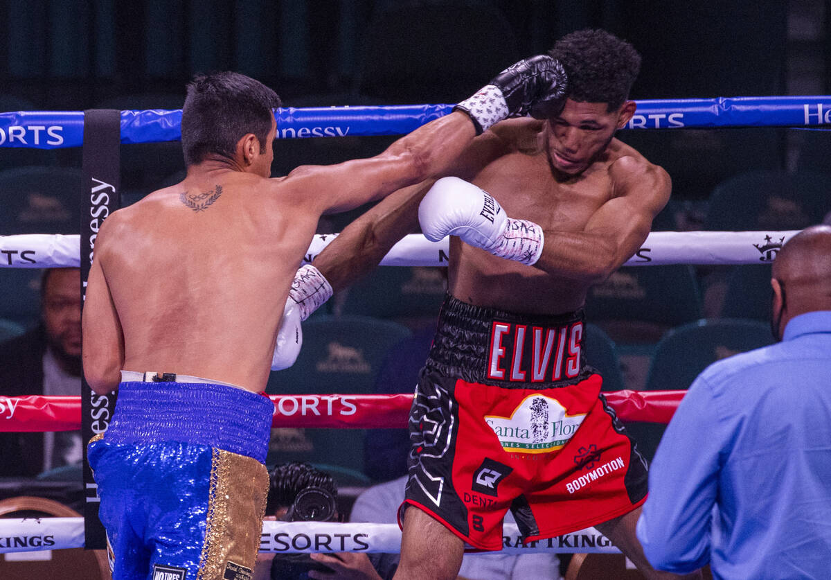 Juan Pablo Romero, left, connects with a punch on Elvis Rodriguez in the first round during the ...