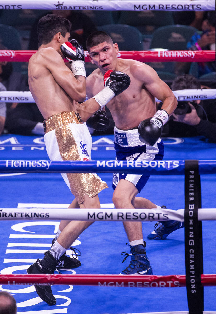 Rey Vargas takes a punch from Leonardo Baez in round 1 during their super bantamweight fight at ...