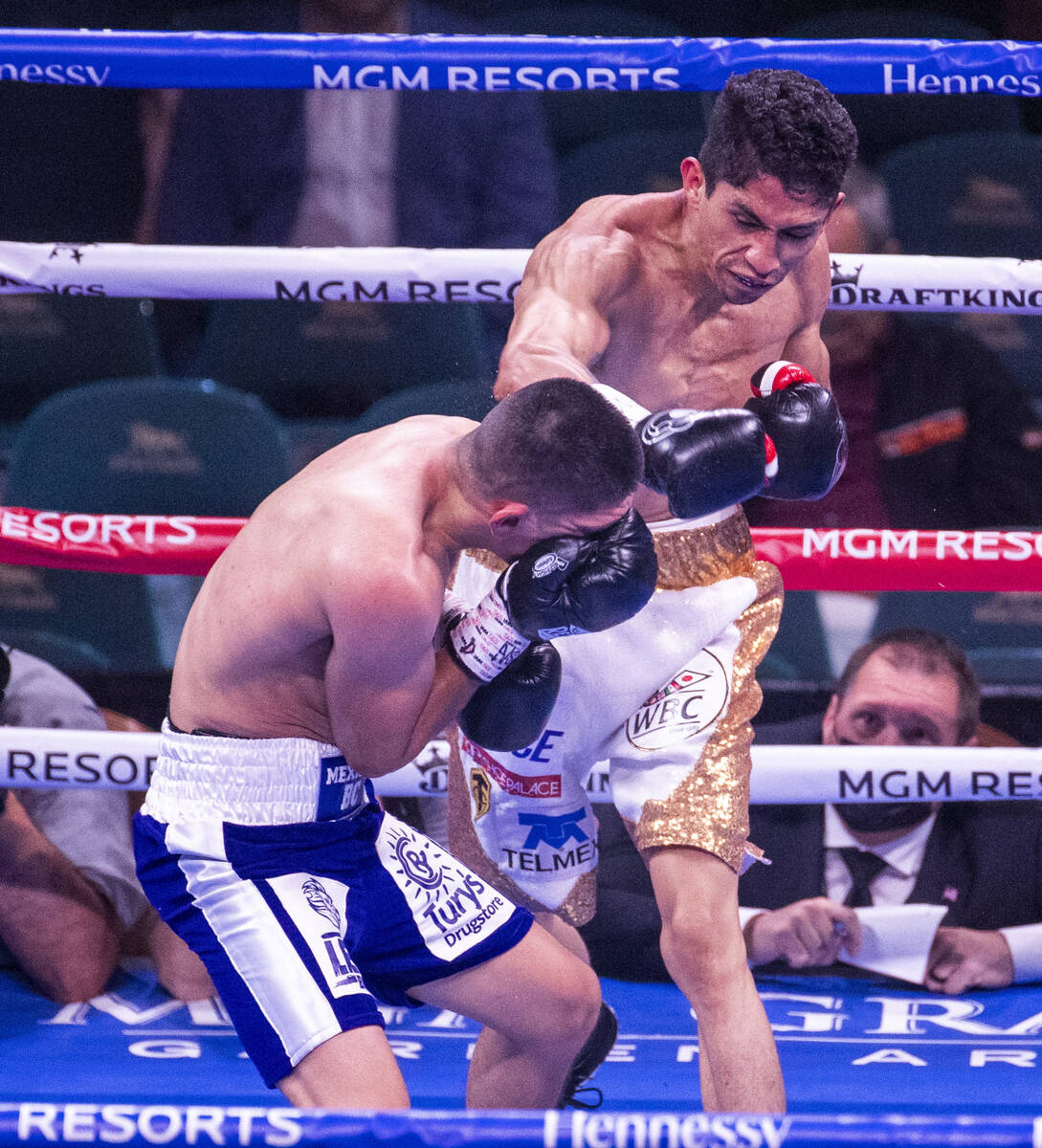 Rey Vargas connects with the head of Leonardo Baez in round 2 during their super bantamweight f ...