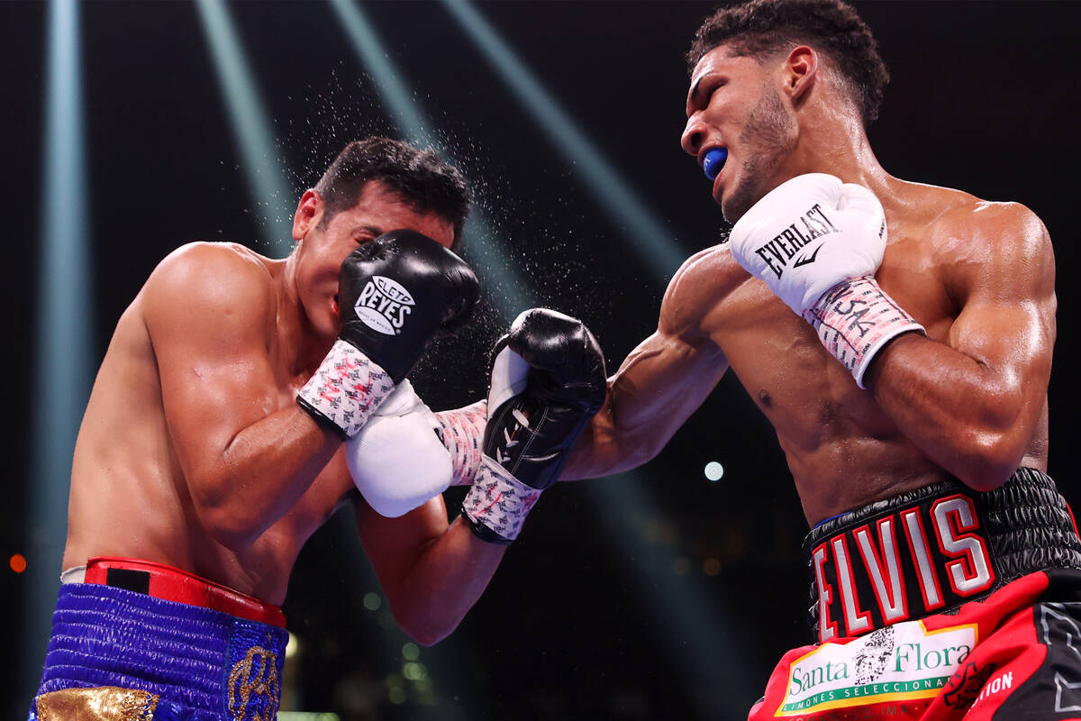 Elvis Rodriguez, right, connects against Juan Pablo Romero in the fourth round of a super light ...