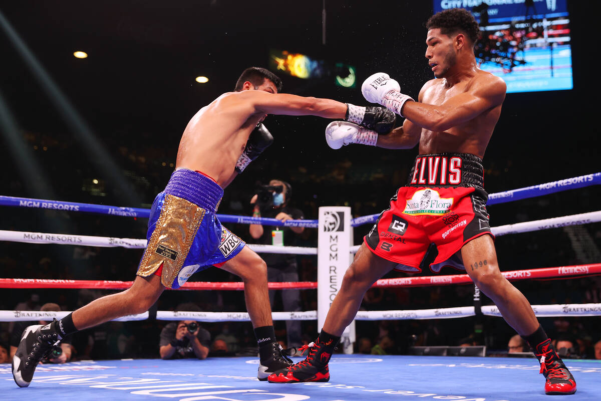 Elvis Rodriguez, right, dodges a punch Juan Pablo Romero in the third round of a super lightwei ...