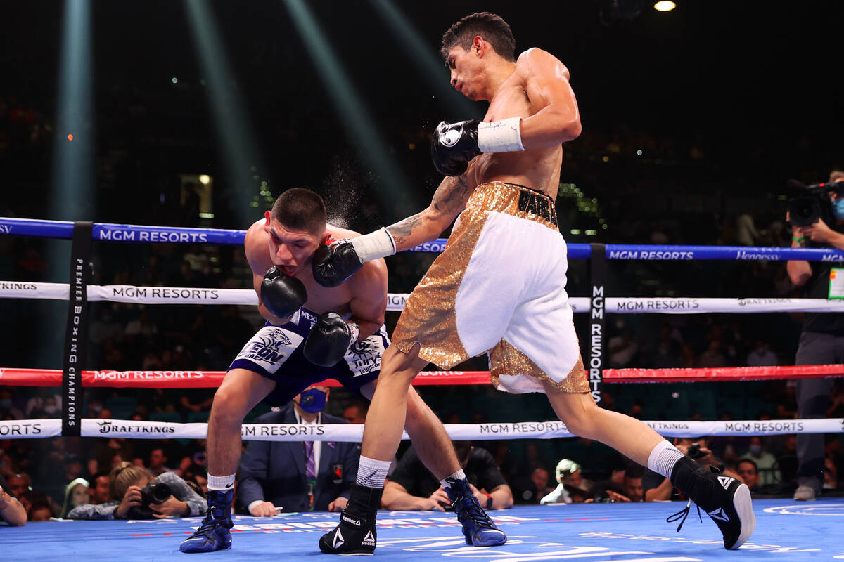 Rey Vargas connects a punch against Leonardo Baez in the sixth round of a featherweight bout at ...