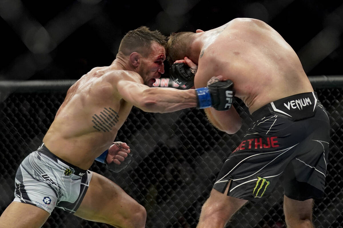 Michael Chandler, left, lands a punch against Justin Gaethje during a lightweight mixed martial ...