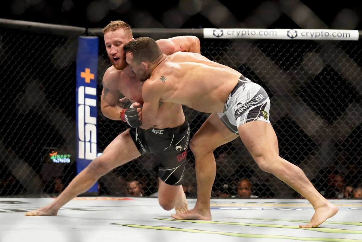 Justin Gaethje, left, grapples with Michael Chandler during a lightweight mixed martial arts bo ...