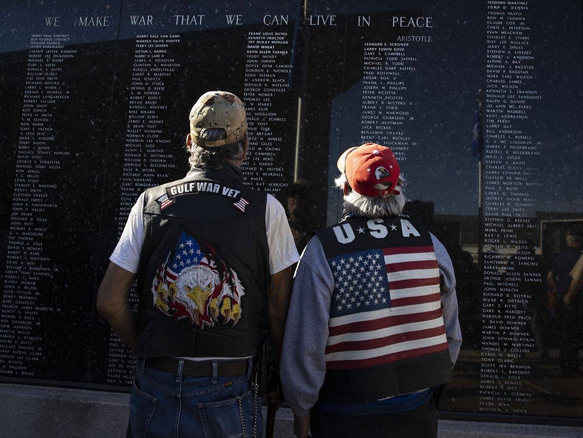 U.S. Army veteran Paul Martinez, 64, left, and retired Army National Guard Teofilo, 66, watch t ...