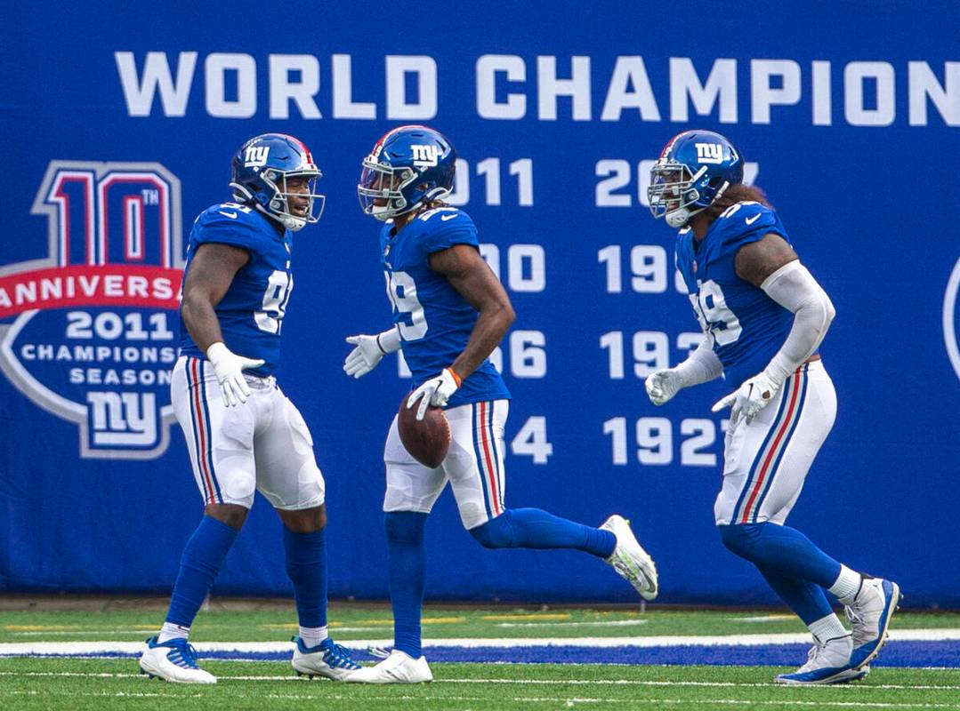 New York Giants free safety Xavier McKinney (29) celebrates his interception and touchdown scor ...