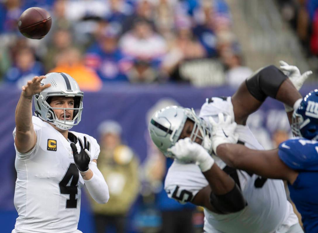 Las Vegas Raiders quarterback Derek Carr (4) makes a contested throw in the second half during ...