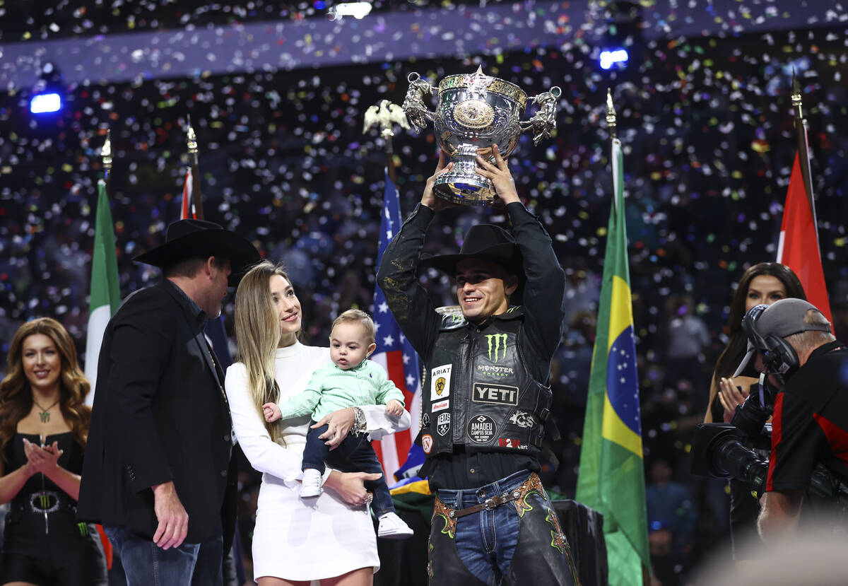 Jose Vitor Leme celebrates alongside his son, Theodoro, and wife, Amanda, after becoming the ba ...