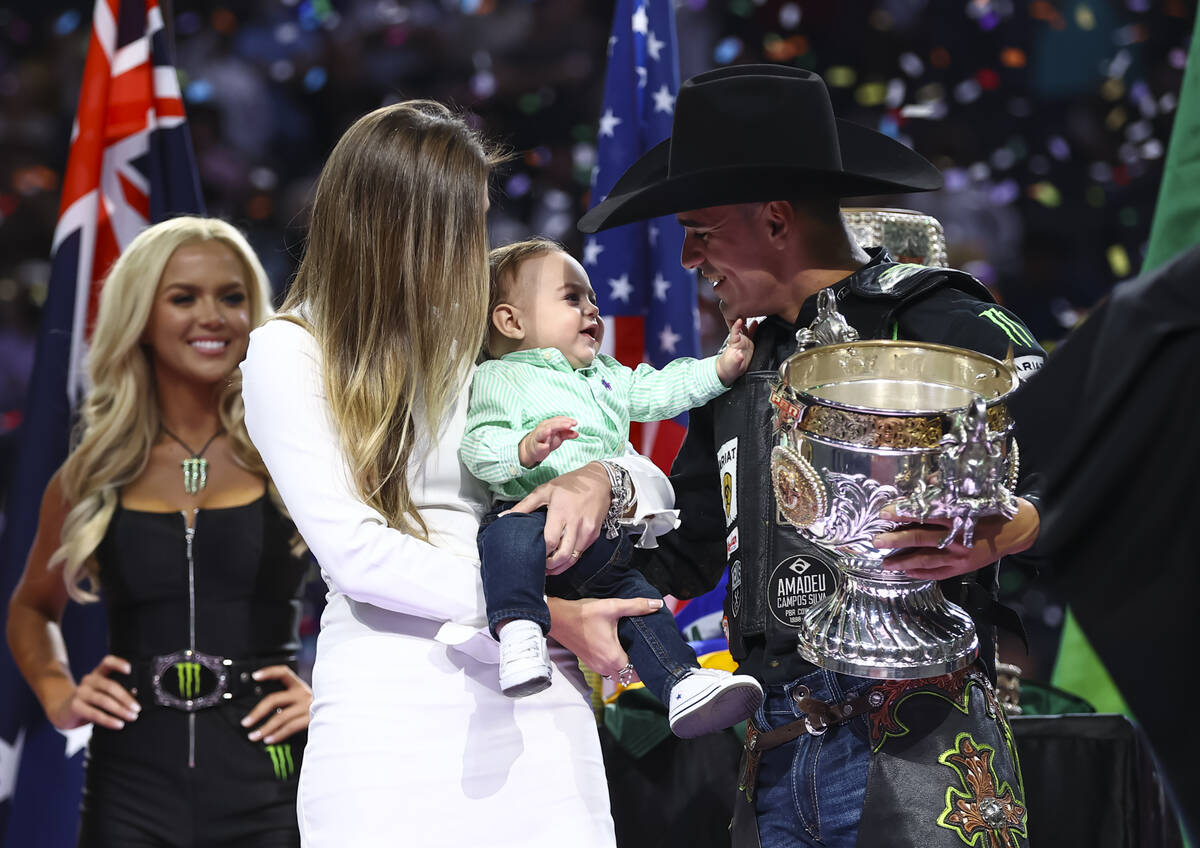 Jose Vitor Leme celebrates with his son, Theodoro, and wife, Amanda, after becoming the back-to ...