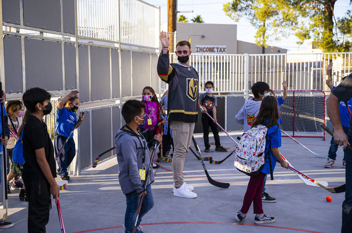 Newly acquired Golden Knights center Jack Eichel raises his hand while participating in a youth ...