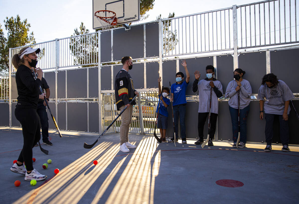 Newly acquired Golden Knights center Jack Eichel (9) helps teach kids during a youth hockey cli ...