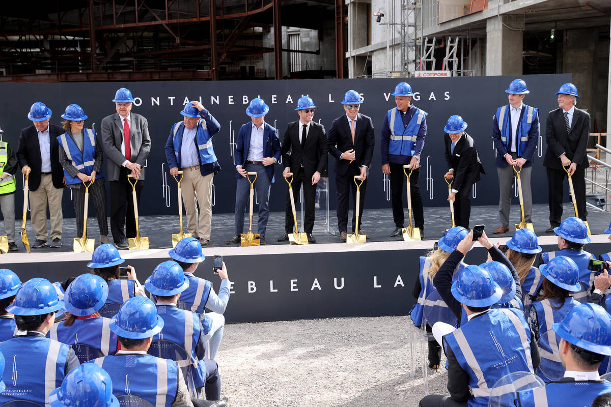 Executives and dignitaries prepare to turn dirt during a commencement ceremony at the yet-to-be ...