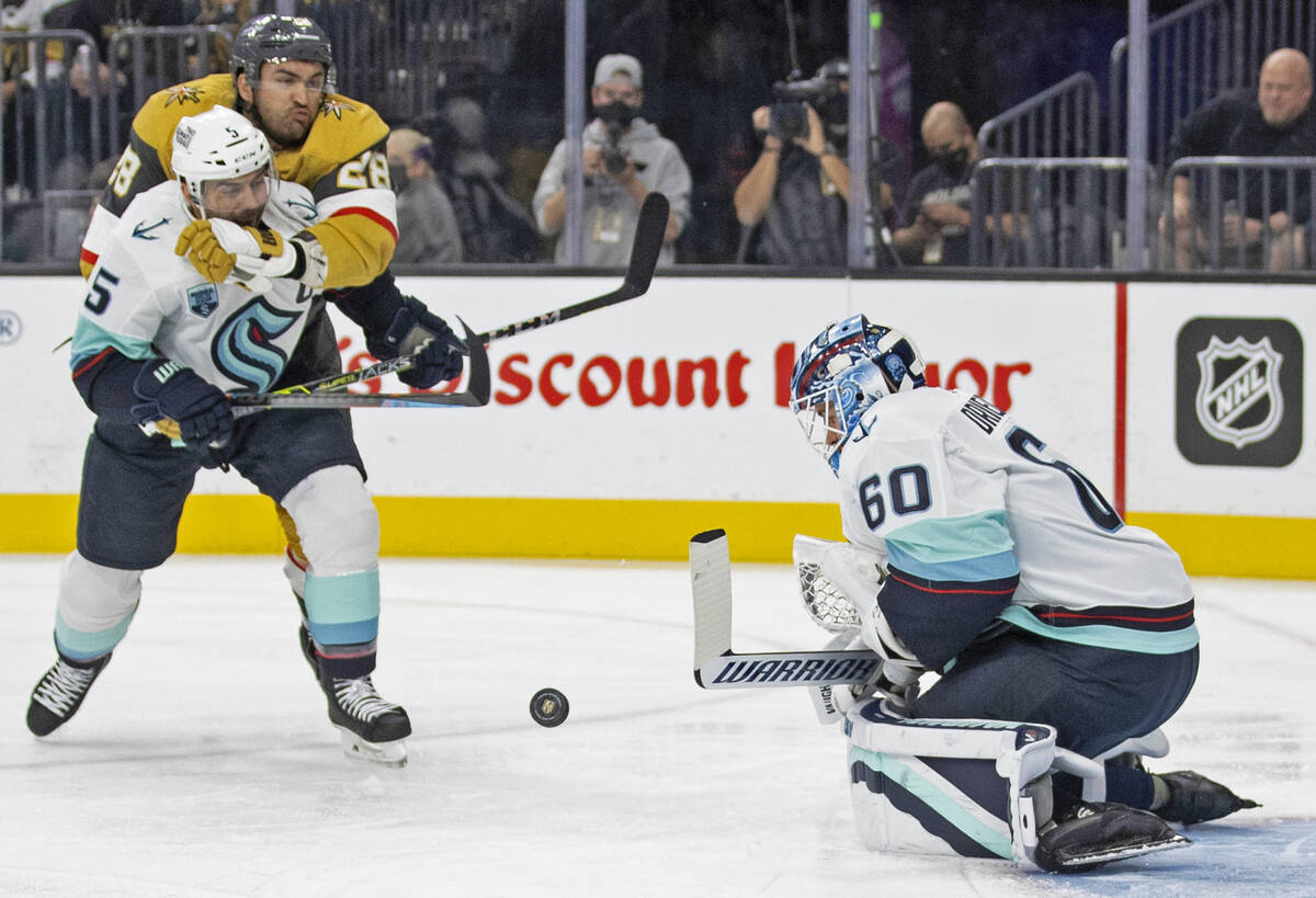 Seattle Kraken goaltender Chris Driedger (60) makes a save against Vegas Golden Knights left wi ...