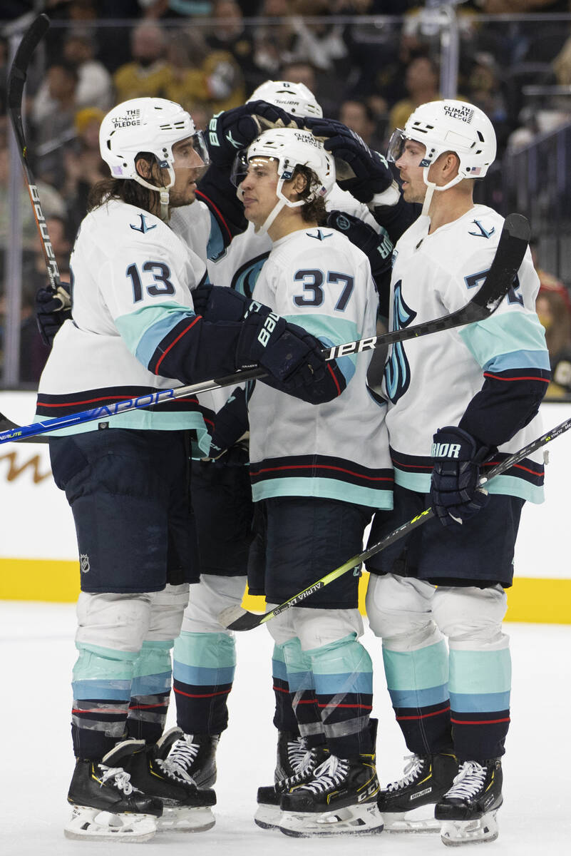 Seattle Kraken center Yanni Gourde (37) celebrates with teammates after scoring a goal in the s ...