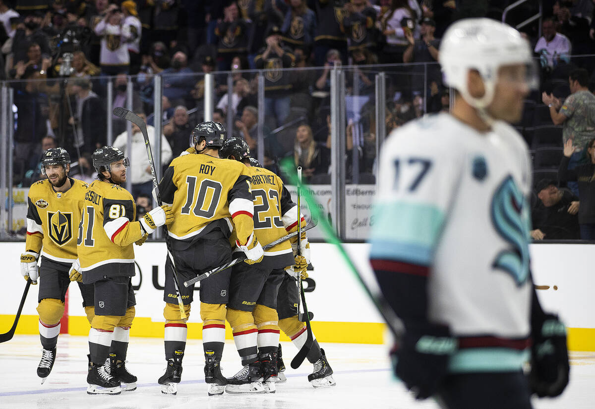 Vegas Golden Knights defenseman Shea Theodore (27) celebrates with teammates after scoring a go ...