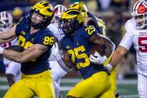 Michigan running back Hassan Haskins (25) rushes in the third quarter of an NCAA college footba ...