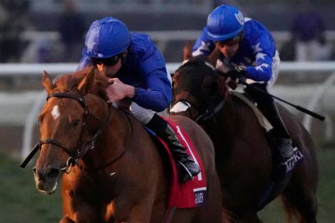 William Buick, left, rides Modern Games to win the Breeders' Cup Juvenile Turf horse race at th ...