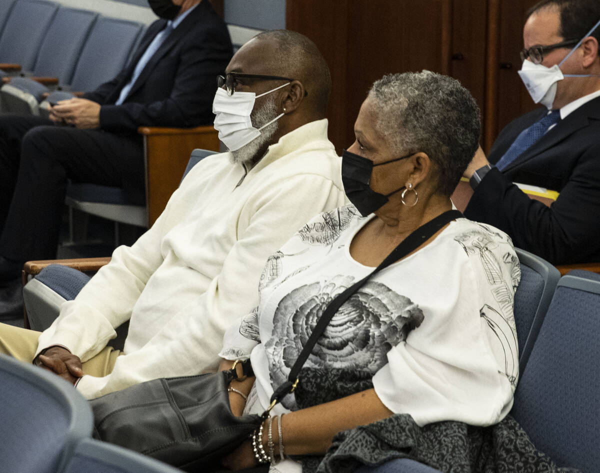Reginald Moore, left, a father of one of the three shooting victims, 14-year-old Jason Moore, s ...