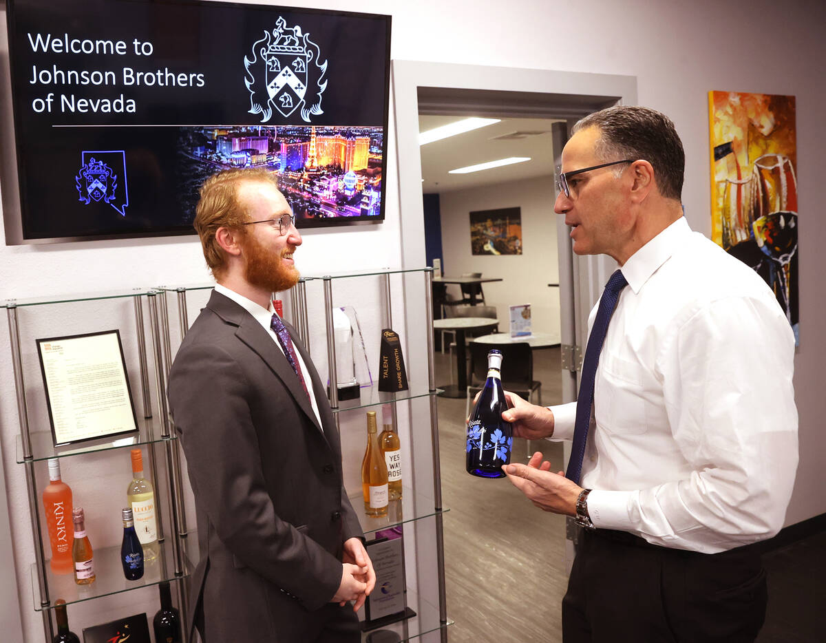 UNLV student Nikolas Fava, left, shadows Gary Charmel, who works in beverage wholesale, at John ...