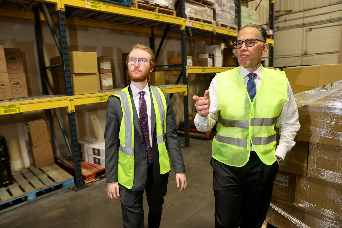 UNLV student Nikolas Fava, left, shadows Gary Charmel, who works in beverage wholesale, at John ...