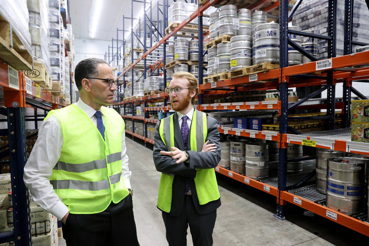 UNLV student Nikolas Fava, right, shadows Gary Charmel, who works in beverage wholesale, at Joh ...