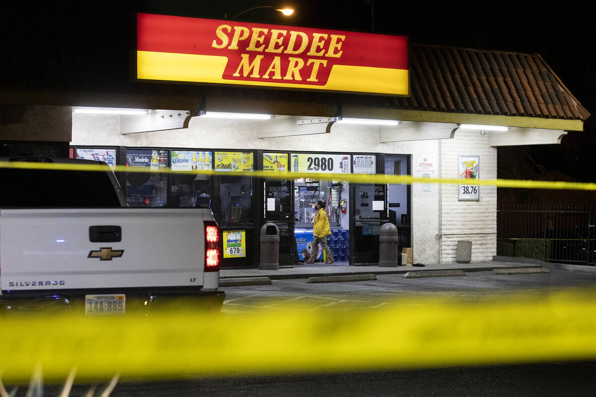 Metropolitan police investigate a homicide at a convenience store near the intersection of McLe ...