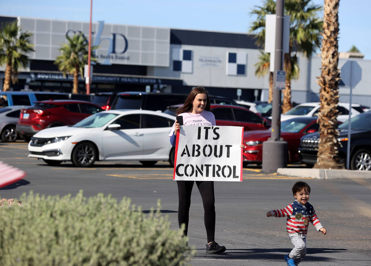 A protester who declined to give her name at Southern Nevada Health District in Las Vegas Wedne ...