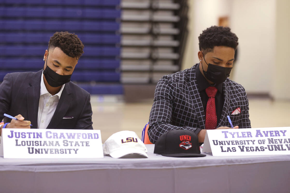 Justin Crawford, left, signs a national letter of intent to play baseball at LSU, while Tyler A ...