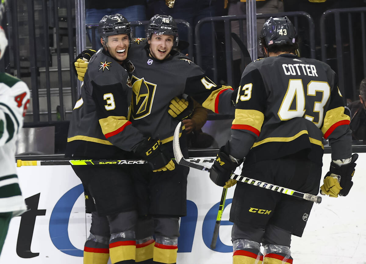 Golden Knights right wing Jonas Rondbjerg, center, celebrates his first NHL goal with defensema ...