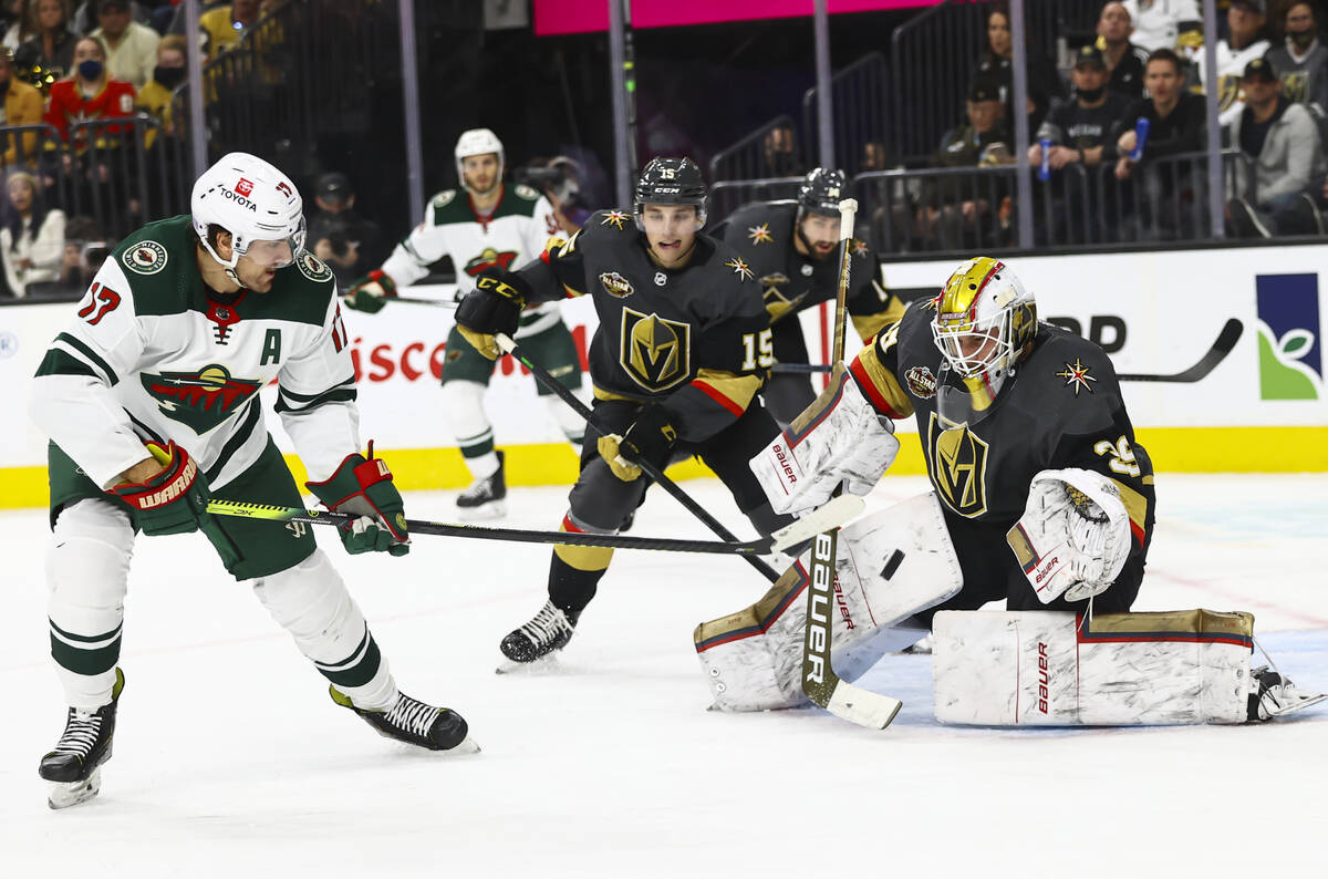 Golden Knights goaltender Laurent Brossoit (39) looks to block a shot from Minnesota Wild left ...