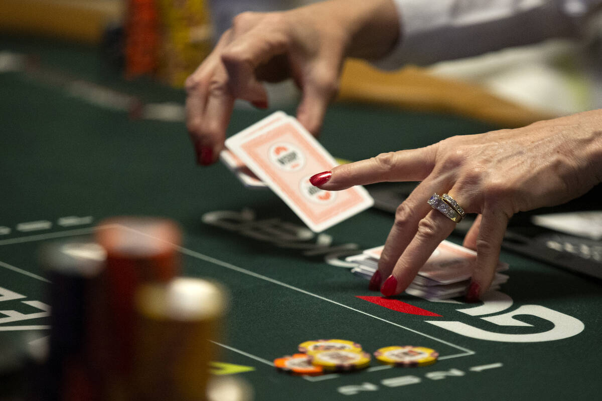 A dealer shuffles cards during the World Series of Poker Main Event at the Rio Convention Cente ...