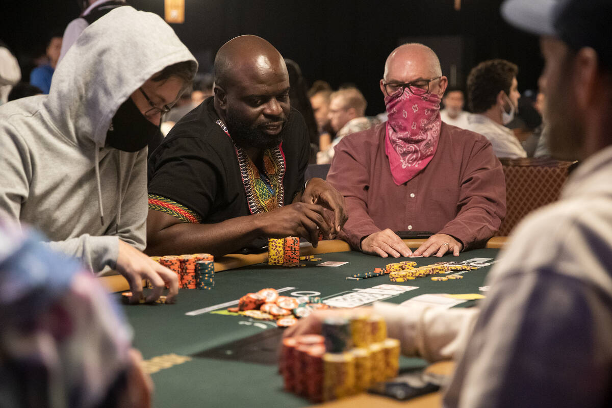 Adedapo Ajayi, of Littleton, Colorado, second from left, weighs a bet during the World Series o ...