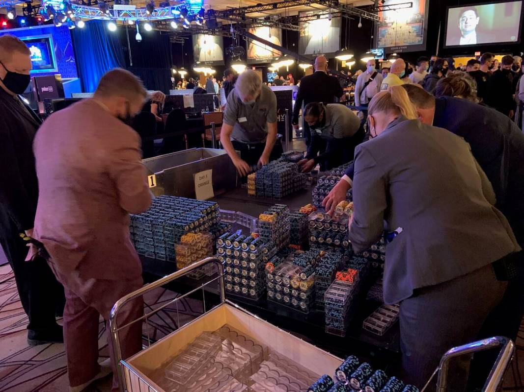 World Series of Poker staffers collect the 100 denomination chips after they were taken out of ...