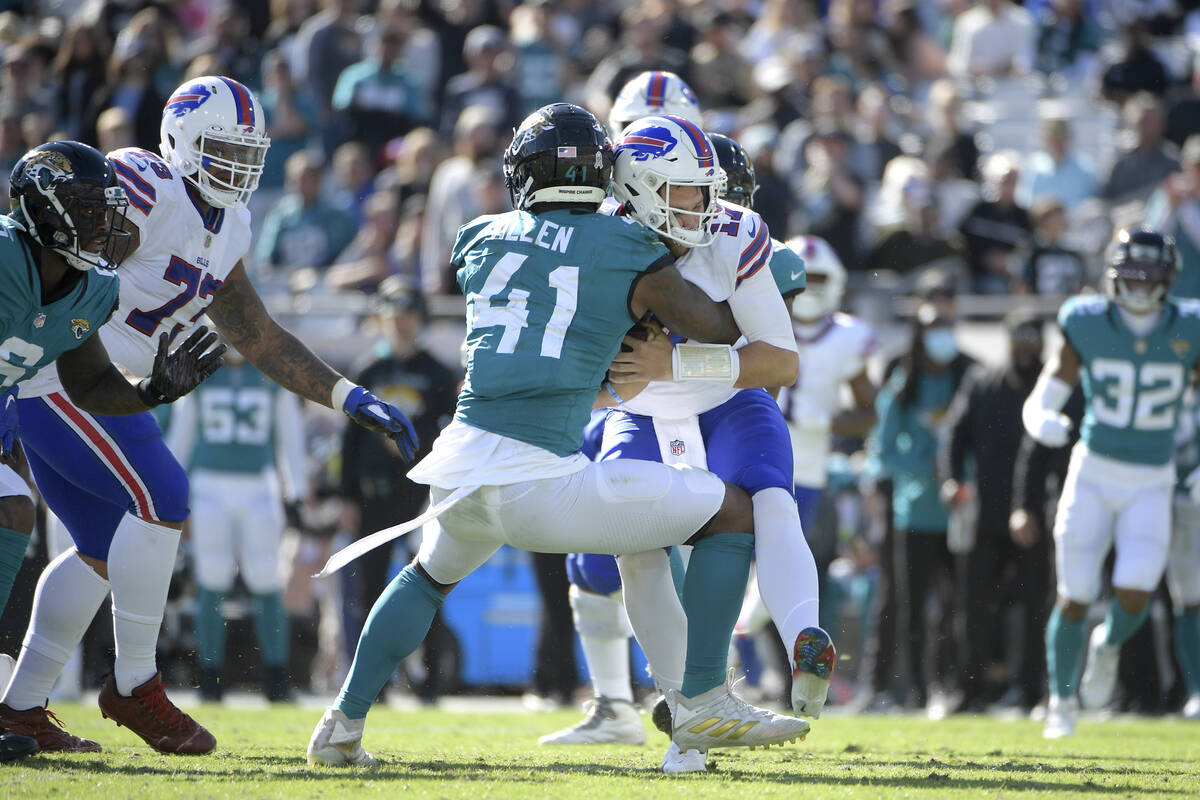 Jacksonville Jaguars outside linebacker Josh Allen (41) tackles Buffalo Bills quarterback Josh ...