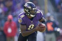 Baltimore Ravens quarterback Lamar Jackson runs with the ball against the Minnesota Vikings dur ...