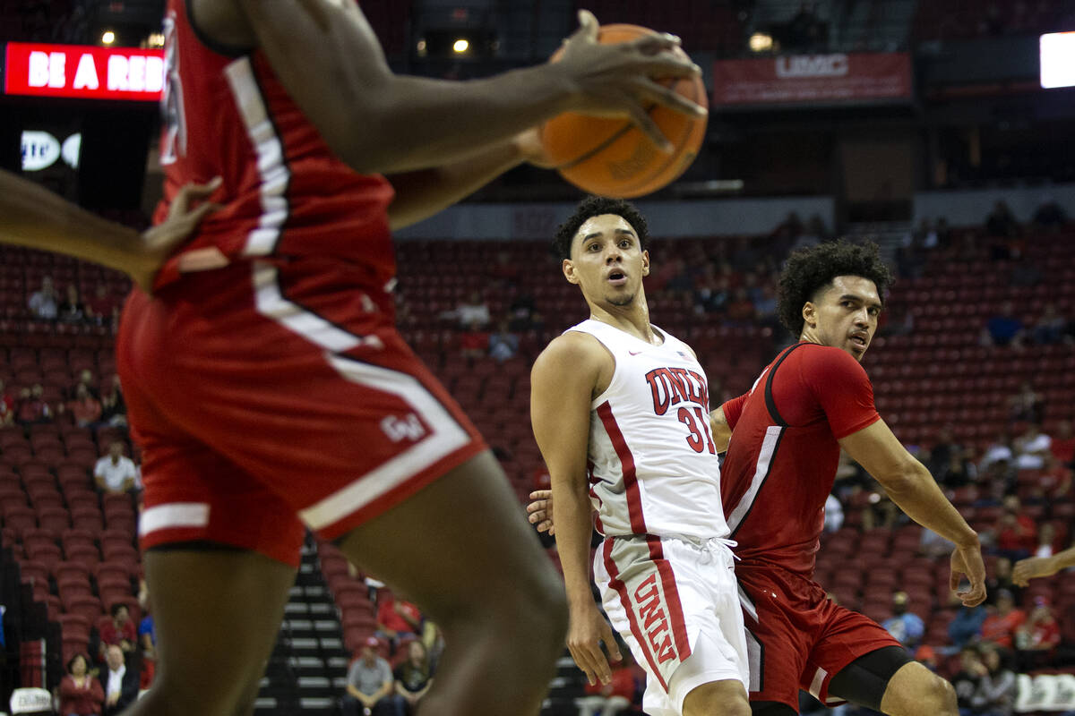 UNLV Rebels guard Marvin Coleman (31) and Gardner Webb Runnin Bulldogs guard D'Maurian Williams ...