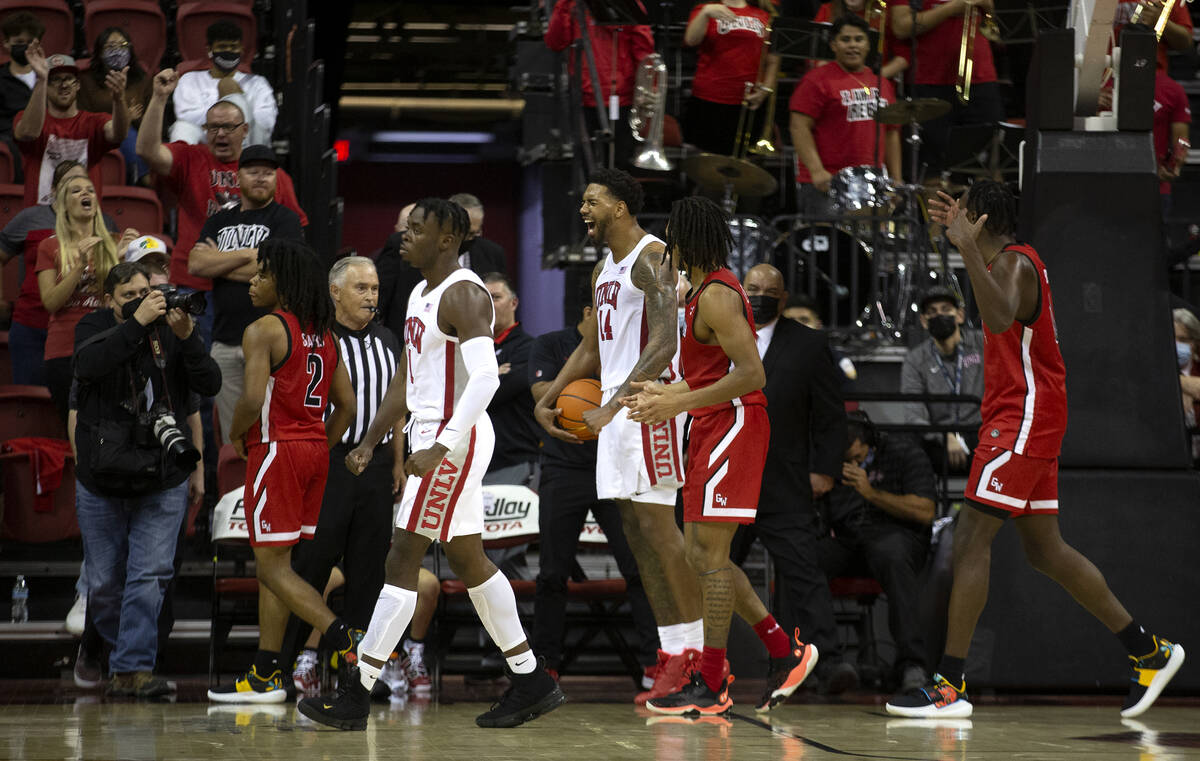 UNLV Rebels forward Royce Hamm Jr. (14) and guard Mike Nuga (1) celebrate a blocked point by Ha ...