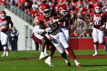 Arkansas receiver Treylon Burks (16) tries to get away from Mississippi State defender Fred Pet ...